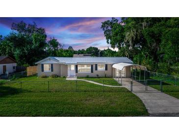 Charming home featuring a metal roof, covered parking, and well-maintained landscaping at 15 Palmira Rd, Debary, FL 32713