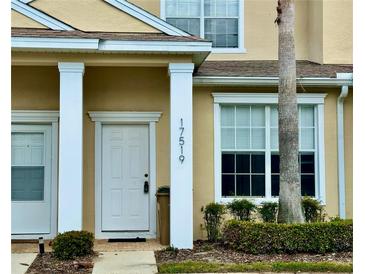 Inviting front door entrance with white columns and well-maintained landscaping at 17519 Blessing Dr, Clermont, FL 34714