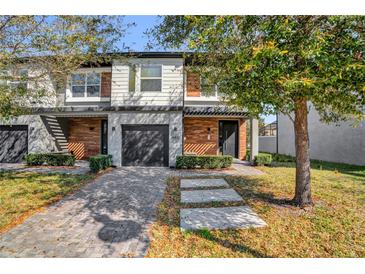 Charming townhouse with a well-manicured front yard, paver driveway and inviting entrance, showcasing the architectural details at 4431 Le Reve Ct, Kissimmee, FL 34746