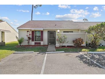 Charming single story villa with quaint front garden and dedicated parking at 56 Pine Island Cir, Kissimmee, FL 34743