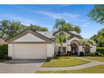 Charming single-Gathering home featuring a two-car garage, arched entryway and fresh landscaping at 8534 Black Mesa Dr, Orlando, FL 32829