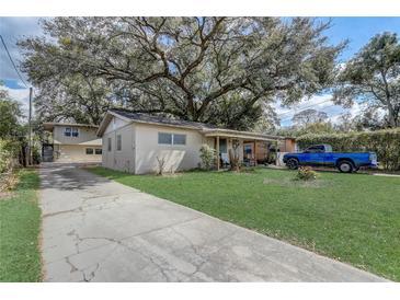 Charming single-story home with mature landscaping, large front yard and long driveway at 1707 Wilton Ave, Orlando, FL 32805