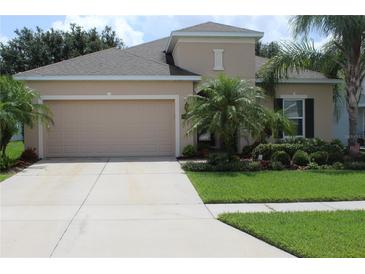 Charming home featuring a well-manicured lawn, attractive landscaping, and a spacious two-car garage at 4110 Arlington Ridge Blvd, Leesburg, FL 34748