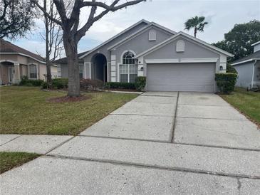 Charming single Gathering home featuring a well maintained lawn and two car garage at 527 Buckhaven Loop, Ocoee, FL 34761