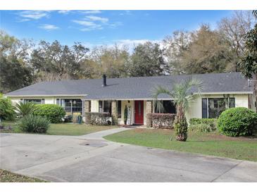 Charming single-story home features lush landscaping, a welcoming front porch, and a well-maintained yard at 2525 W Ponkan Rd, Apopka, FL 32712
