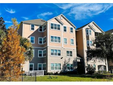 Charming condo building showcasing architectural details, lush landscaping and inviting curb appeal at 3428 Soho St # 308, Orlando, FL 32835