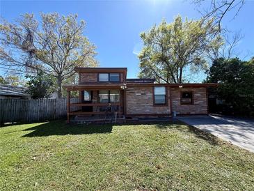 Charming single-story home with stone facade, covered porch, and well-maintained front lawn at 3522 Wd Judge Dr, Orlando, FL 32808