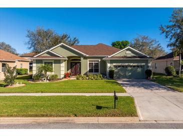 Charming single-story home with well-manicured lawn, mature landscaping, and inviting curb appeal at 3696 Peacepipe Ct, Clermont, FL 34711