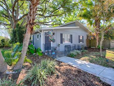Charming home featuring well-manicured landscaping and a welcoming, grey exterior at 500 E Crystal Lake St, Orlando, FL 32806