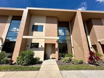 Modern two-story home featuring sleek architecture and well-maintained landscaping at 7534 Brooklyn Dr, Kissimmee, FL 34747