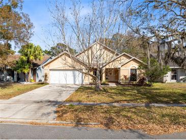 Charming single-Gathering home features a well-manicured lawn, two car garage and mature landscaping at 835 Longleaf Pine Ct, Orlando, FL 32825