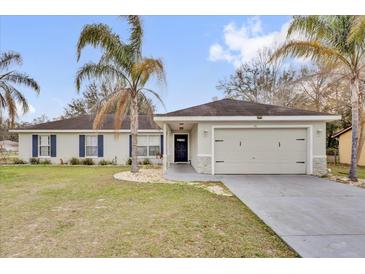 Charming single-story home with a two-car garage and manicured lawn at 96 Pecan Dr, Ocala, FL 34472