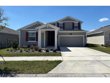 Charming two-story home with landscaped yard, neutral paint, and a two-car garage at 2006 Myrtle Pine St, Kissimmee, FL 34746