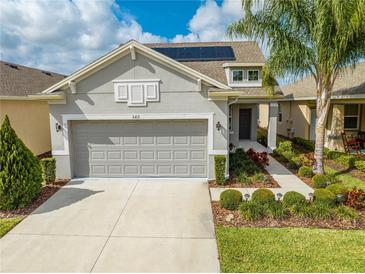 Charming single-Gathering home featuring a two-car garage, solar panels, and mature landscaping at 3415 Sagebrush St, Harmony, FL 34773