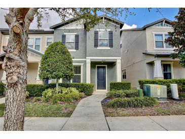 Charming two-story home featuring a well-manicured front yard with lush landscaping and walkway at 5025 Walker St, St Cloud, FL 34771