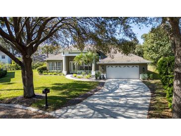 Charming single-story home with a manicured lawn, mature trees, and a two-car garage at 806 Roswell Cv, Lake Mary, FL 32746