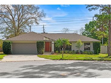 Charming single-story home with a well-maintained lawn and a two-car garage at 9360 Sonia St, Orlando, FL 32825