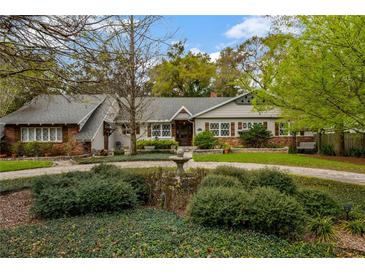 Charming home with a landscaped front yard, water feature and brick and siding facade at 1800 Wycliff Dr, Orlando, FL 32803