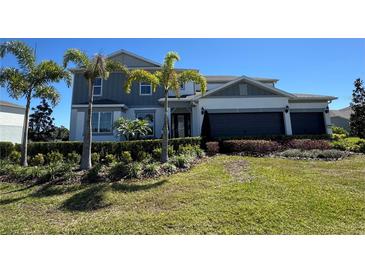 Beautiful two-story home with a well-manicured lawn, mature landscaping, and a two car garage at 2135 Weatherly Way, Orlando, FL 32820