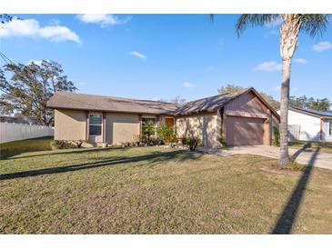 Charming single-story home with a well-manicured lawn and attached garage at 288 Garland, Deltona, FL 32725