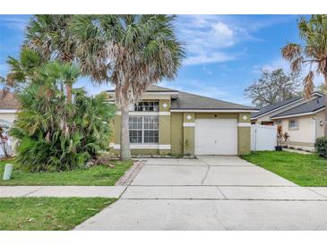 Charming single-story home with a well-maintained lawn, driveway, and attached garage at 3288 Brewster Dr, Kissimmee, FL 34743