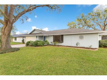 Charming single-story home with well-manicured lawn and mature trees in a peaceful neighborhood at 4029 Cool Water Ct, Winter Park, FL 32792