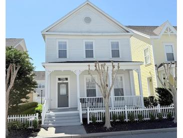 Charming two-story home with a welcoming front porch and well-maintained landscaping at 802 Rosa St, Celebration, FL 34747