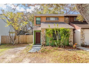 Charming townhome exterior features unique rock accents and lush landscaping at 12240 Huntsman Ln, Orlando, FL 32826