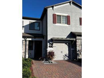 Charming townhouse with a brick-paved driveway and a well-maintained front yard at 272 Cedar Bark Ln, Sanford, FL 32771