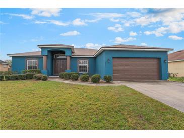 Charming single-story home with well-maintained lawn, blue exterior, and brown accents at 2851 Stonewood Cir, Lakeland, FL 33810