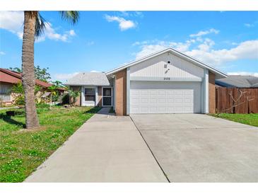 Charming single-Gathering home boasting a two-car garage and beautiful lawn at 3175 Arrowhead Ln, Kissimmee, FL 34746