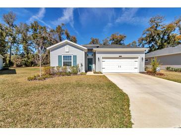 Charming single-story home with a well-manicured lawn and attached two-car garage at 7651 Sw 74Th Loop, Ocala, FL 34481