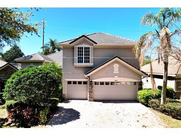 Charming two-story home with a three-car garage and beautiful landscaping at 8854 Oak Landings Ct, Orlando, FL 32836