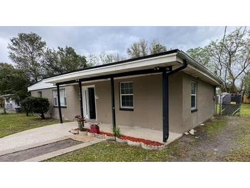 Charming single-story home with a covered porch and landscaped flowerbeds at 11618 Churchill St, Orlando, FL 32817