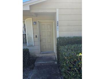 Inviting front door entrance of home with well-maintained landscaping at 1168 Woodman Way, Orlando, FL 32818