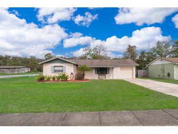 Charming single-story home features a manicured lawn, driveway, and inviting front entry at 147 13Th Ave, Longwood, FL 32750