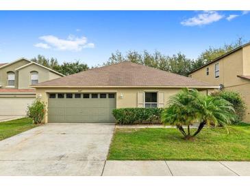 Charming single-story home features a well-manicured lawn and an attached two-car garage at 16817 Gold Star Ct, Clermont, FL 34714