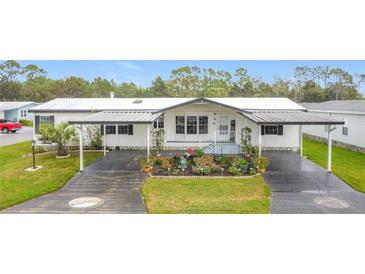 The well-maintained home features covered parking, manicured landscaping and inviting front entrance at 200 Patricia Pl, Davenport, FL 33897