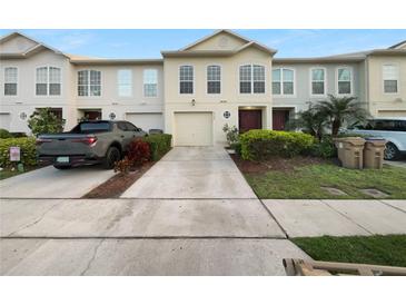 Charming townhouse featuring a private driveway, attached garage, and well-maintained landscaping at 2722 Dodds Ln, Kissimmee, FL 34743