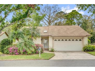 Charming single-story home featuring a two-car garage, mature landscaping, and a welcoming front entrance at 769 Dunlap Cir, Winter Springs, FL 32708