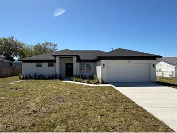 Inviting single-story home with a manicured front lawn and an attached garage at 917 Swallow St, Deltona, FL 32725