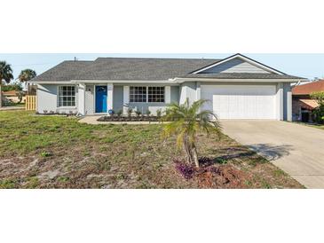 Charming single-story home with gray exterior, well-maintained lawn, and attached garage, offers curb appeal at 2169 Webster Ct, Deltona, FL 32738