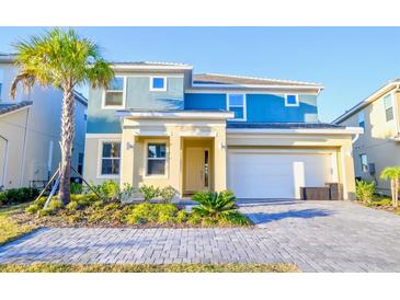 Beautiful two-story home featuring a modern design, well-maintained landscaping, and an attached two-car garage at 2555 Shanti Dr, Kissimmee, FL 34746