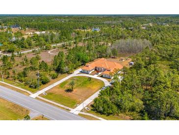 Aerial view showcasing the home's location on a large, wooded lot at 6005 Bancroft Blvd, Orlando, FL 32833