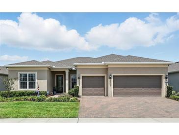 Charming single-story home featuring a well-maintained lawn, a paver driveway, and a neutral-toned exterior at 6117 Sandy Springs Ct, St Cloud, FL 34771