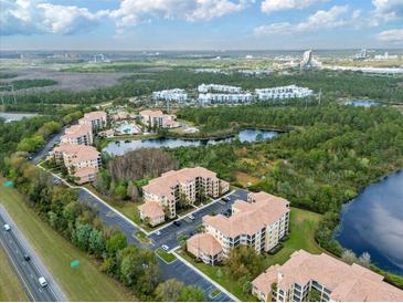 Beautiful aerial view of condos with lush landscaping, ponds, and convenient parking at 8763 Worldquest Blvd # 5306, Orlando, FL 32821