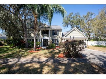 Charming two-story home with lush landscaping, mature trees and ample curb appeal on a sunny day at 1770 Nordic Ct, Apopka, FL 32712