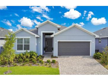 Charming single-Gathering home with a two-car garage, manicured lawn and beautiful landscaping at 2348 Victoria Dr, Davenport, FL 33837