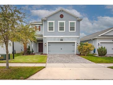 Charming two-story home with a brick paver driveway and well-maintained landscaping at 3010 Ballad Rd, Kissimmee, FL 34746