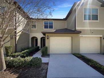 Townhome boasts a well-maintained exterior and attached garages at 3020 Alessa Loop, Apopka, FL 32703